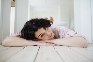 Brunette young woman lying on floor