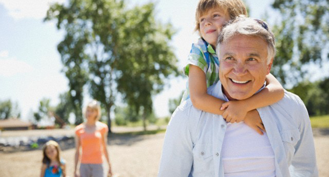 Grandfather giving grandson piggyback